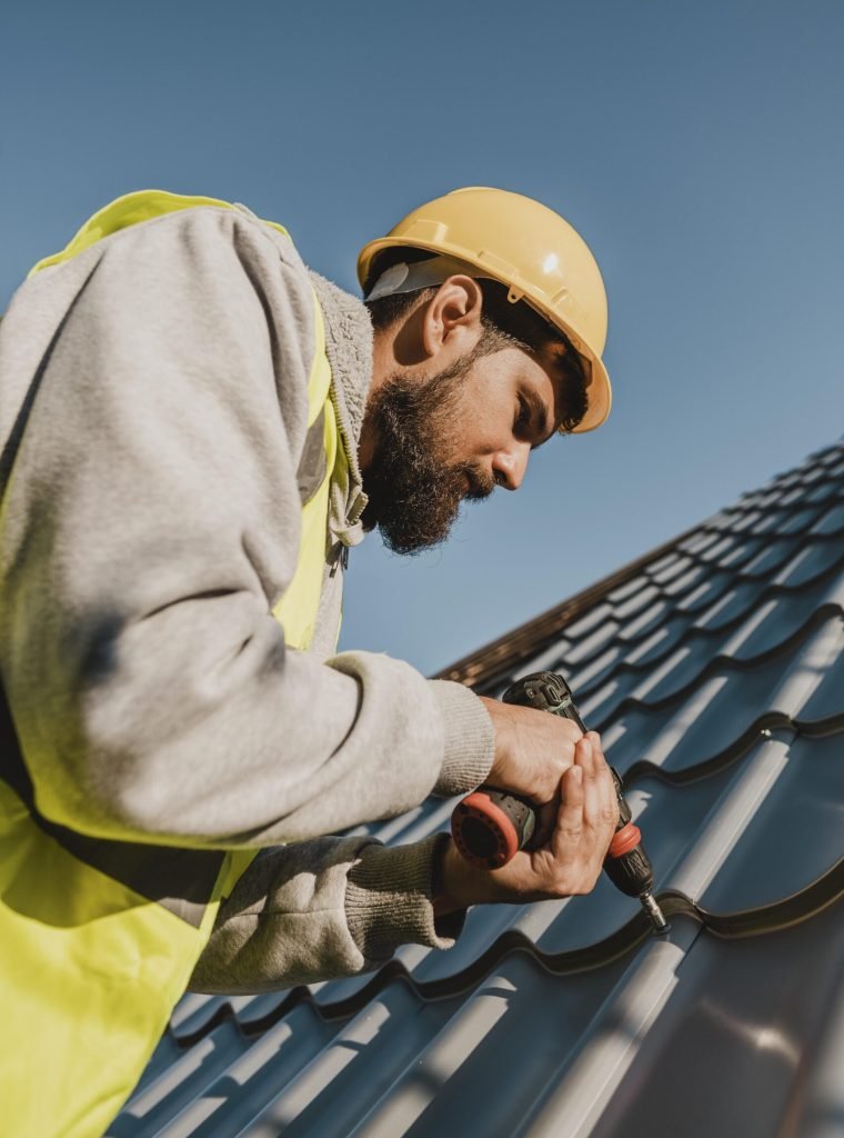 man-working-roof-with-drill-low-view man-working-roof-with-drill-low-view